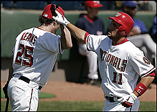 Ryan Zimmerman, right, is congratulated by Austin Kearns after hitting a home run in the Nationals' 9-6 exhibition victory. Zimmerman and the Mets' David Wright, both third basemen, grew up in the Tidewater area. (By Julie Jacobson -- Associated Press)